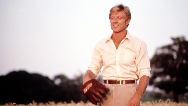 alt="The Natural movie featuring Robert Redford with a baseball mitt in a field"